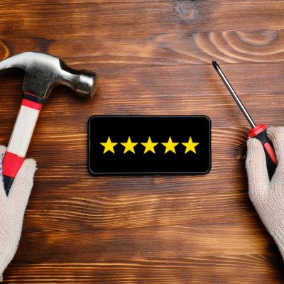 Hands holding tools around a phone with five-star rating.