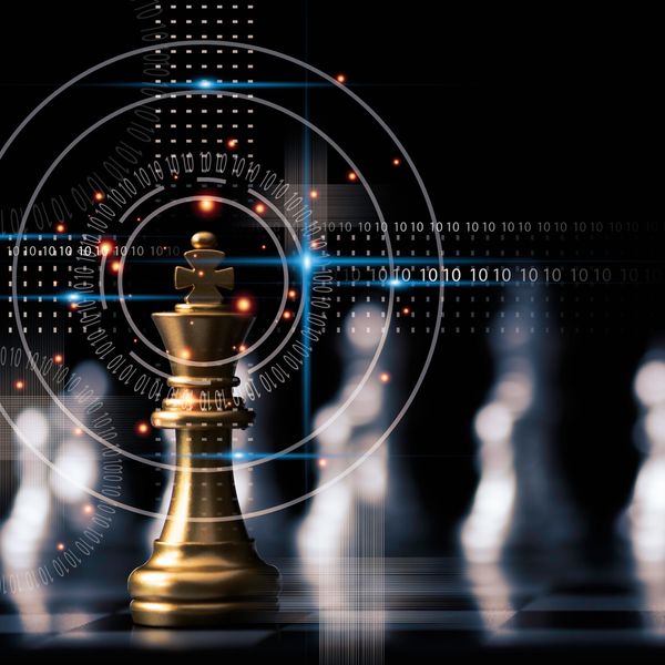 Golden chess king piece with digital binary code and futuristic graphics.