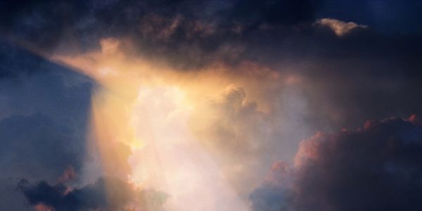 Sunlight breaking through dark clouds.