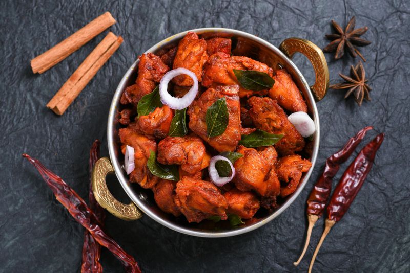Fried chicken Kebab or Kabab, Chicken Tikka Masala on dark black background Bangalore Hyderabad South India. Top view of Indian non veg food.