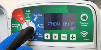 Smart irrigation controller being programmed to optimize watering schedules and improve efficiency.
