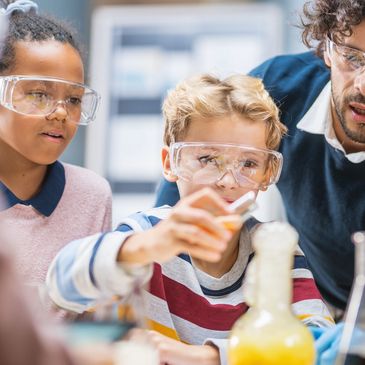 Children conducting a science experiment with a teacher.