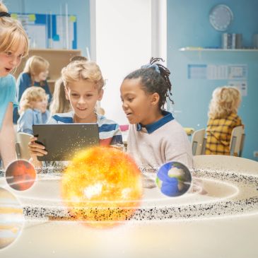 Children exploring a digital solar system model in a classroom.