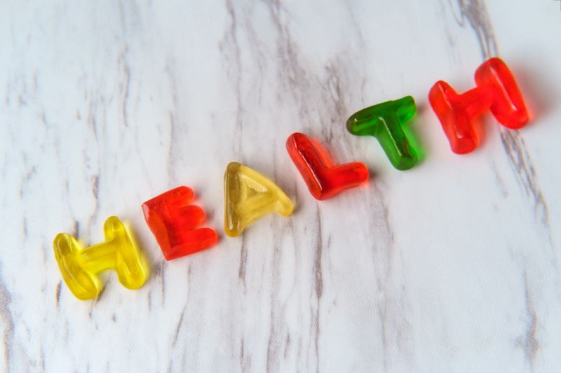 Assorted colorful gummy candy letters spell the word Health
