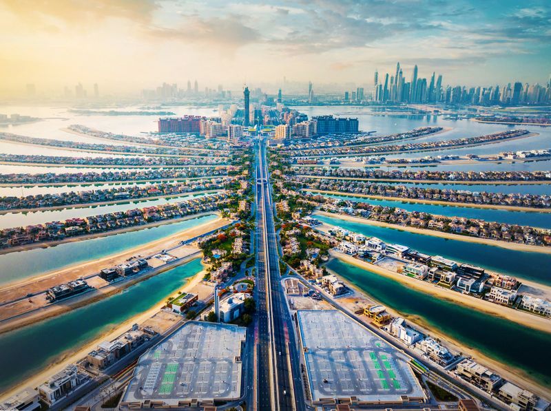 The Palm shaped island in Dubai United Arab Emirates aerial view at sunrise. Famous artificial island with luxury villas and hotels