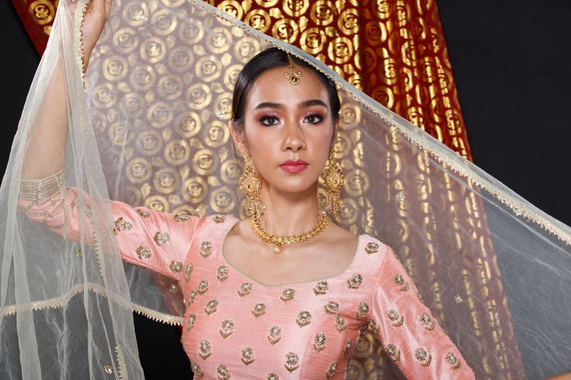 Indian beauty face perfect make up wedding bride, Portrait of a beautiful woman in Red Pink traditional India bridal costume with heavy jewellery and makeup