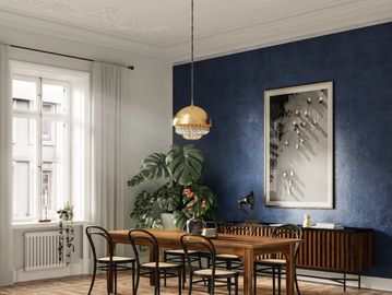 Elegant dining room with wooden table, black chairs, and deep blue accent wall.