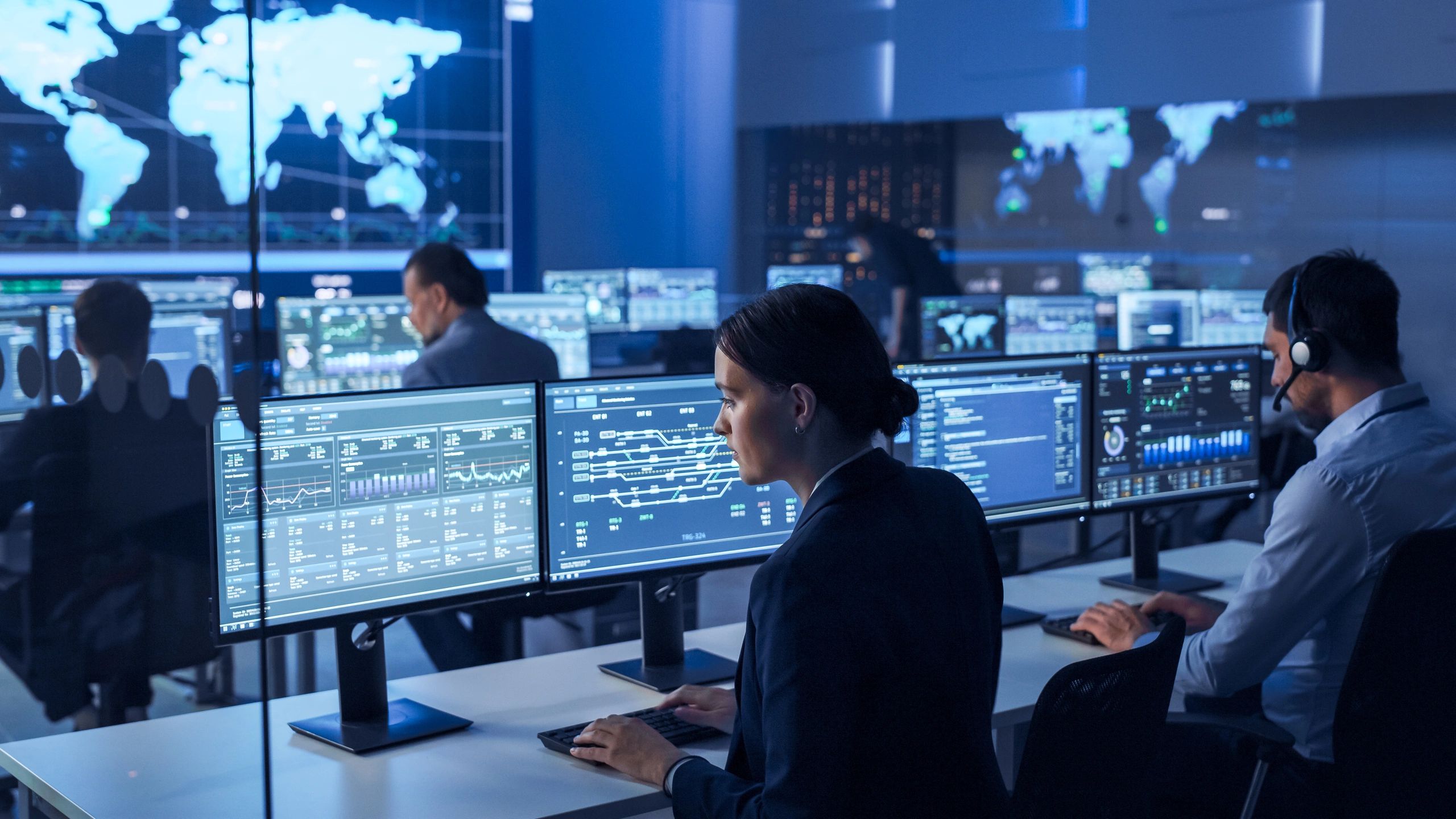 Professionals coordinating complex operations across multiple digital systems in a centralized manag