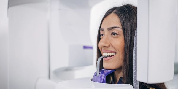 Woman undergoing dental X-ray scan.