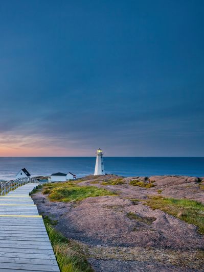 Path leading toward a lighthouse represents seeking healing and direction after family scapegoating.
