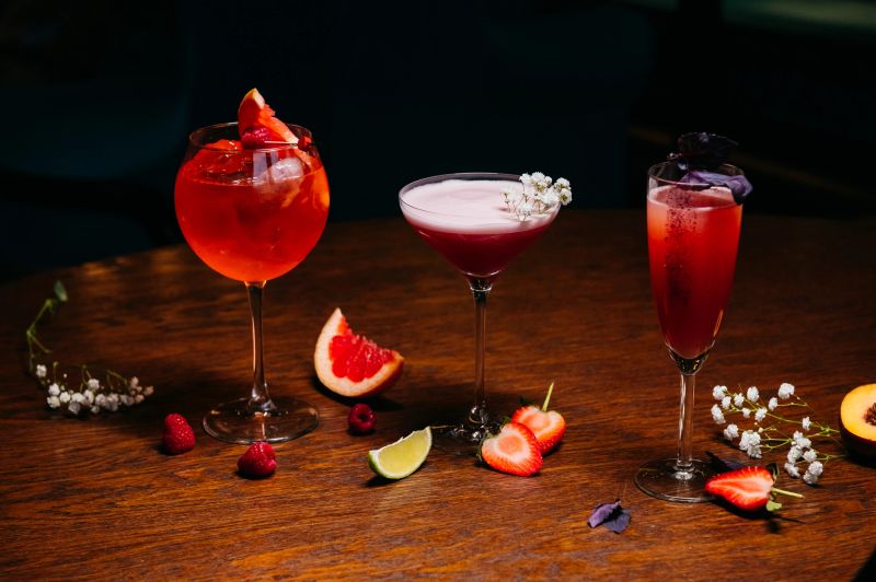 glasses with cocktails on the table in the restaurant with fruits and berries