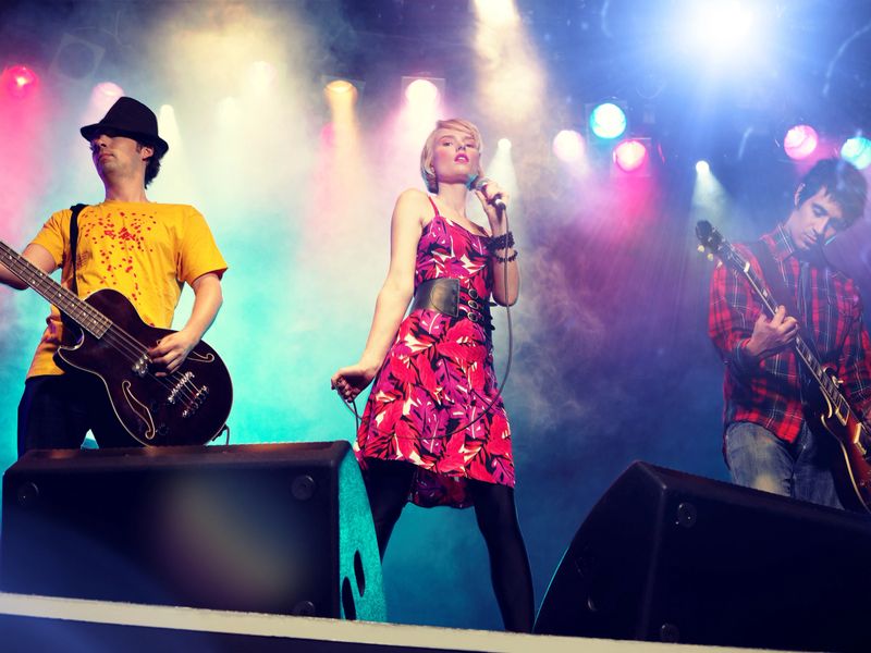 Young female rockstar Singing in Concert