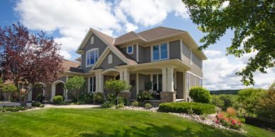 Modern two-story house with landscaped lawn.