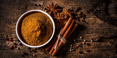 Ground spices with cinnamon sticks and star anise.