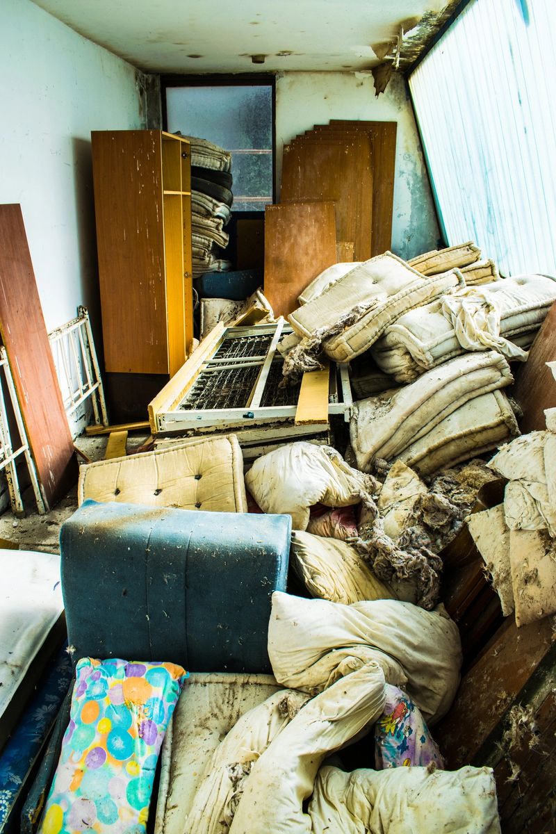 Room full of old furniture. Wardrobe, beds, matraces. Garbage.
