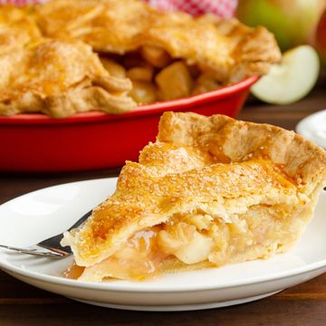 A slice of apple pie on a white plate.