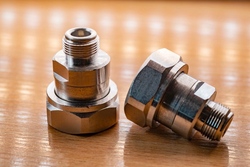 Microwave coaxial adapter 7 16 DIN Male To N Female connector. Concept of radio details. High frequency component with a metallic covering