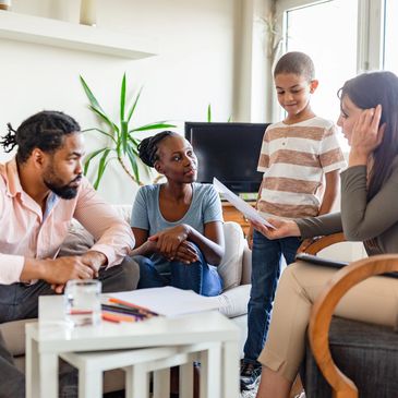 Family discussing schoolwork at home.
