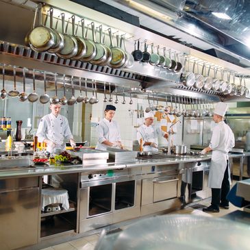 Professional chefs working in a well-equipped commercial kitchen.