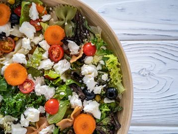 Fresh garden salad with various vegetables and cheese.