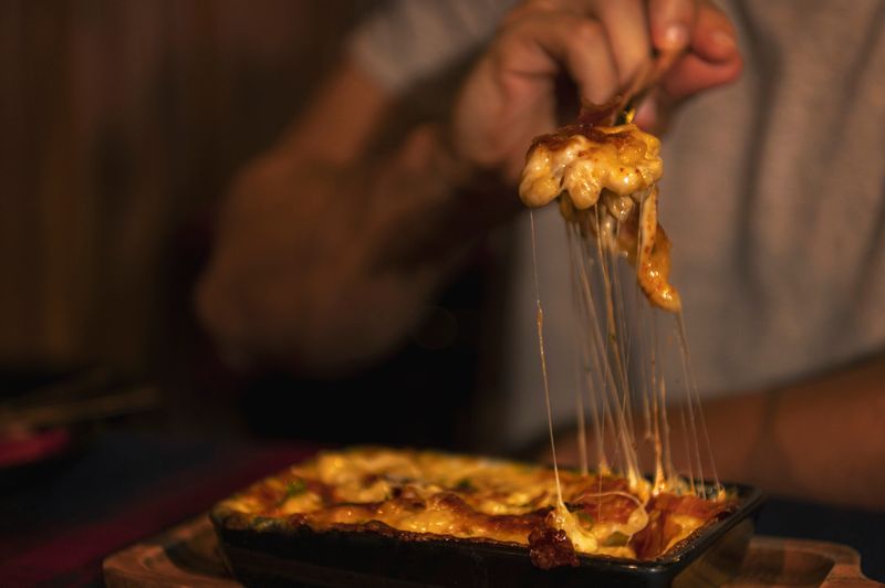 Cheese stretching close up shoot of macaroni and cheese or mac n cheese