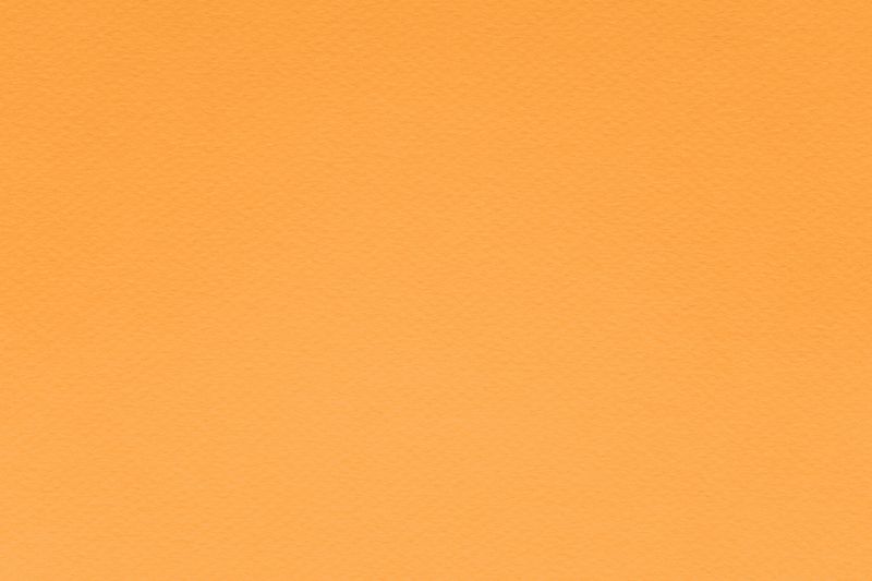 Texture of marigold orange colored paper for watercolor and pastel. Fashionable pantone color of spring-summer 2021 season from fashion week. Modern luxury background or mock up, copy space.