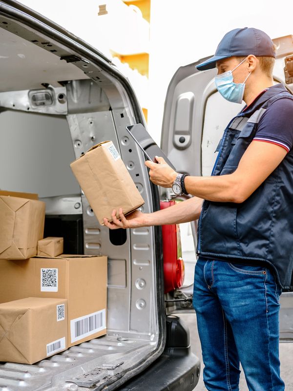 Delivery worker scanning package in van.