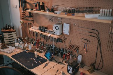 Firearm tools and parts on workbench.