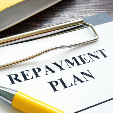 Document titled 'Repayment Plan' with a yellow pen and paperclip.