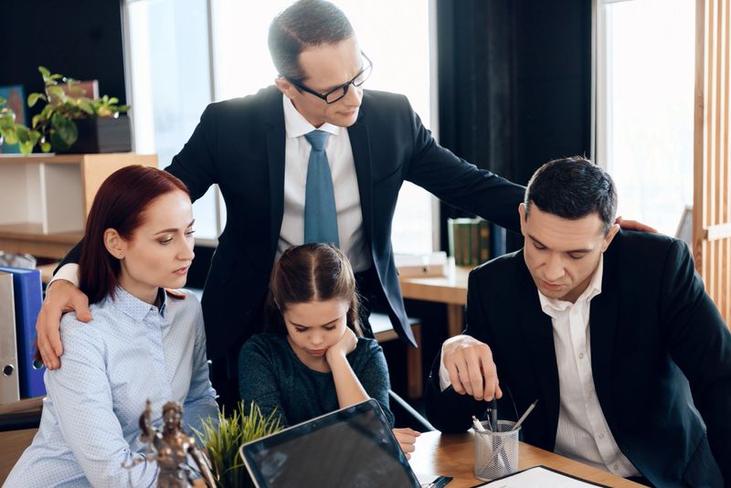 Lawyer calms family down with little girl who gets divorced. Young man and beautiful woman decide who will be main guardian of little girl.