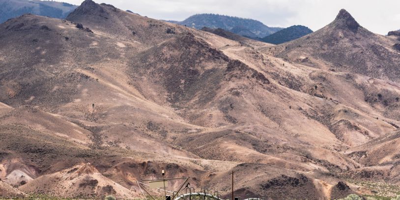 Dry, mountainous landscape under cloudy sky.