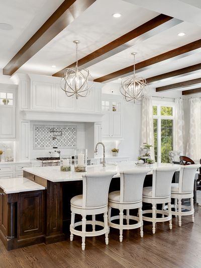 Bright, spacious kitchen with white cabinetry and dark wood accents.