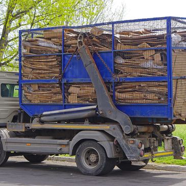 A truck loaded with a blue metal cage full of stacked cardboard.
cleaning services, electricians, expert construction services ,maintenance, residential renovations, waste removal. 
cleaning services, electricians, expert construction services ,maintenance, residential renovations, waste removal 