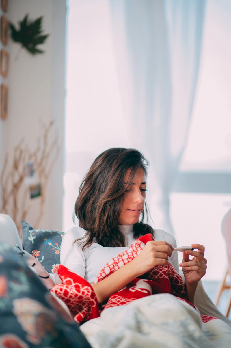 Sick Woman Measuring Her Temperature With Medical Digital Thermometer
