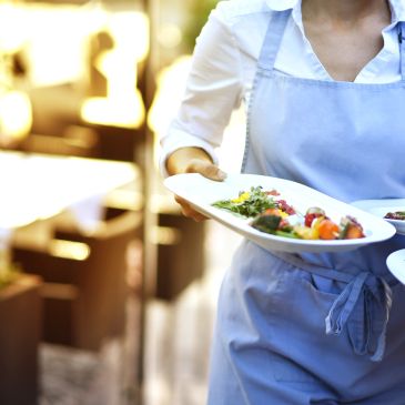 Server carrying dishes in a restaurant.