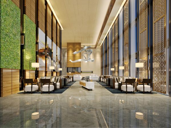 Modern luxury hotel lobby with high ceilings and elegant seating.