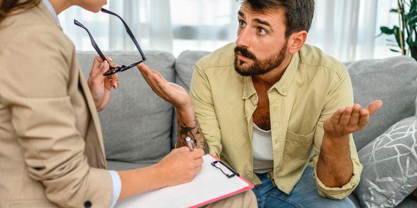 A man talks with a therapist during a counseling session.
