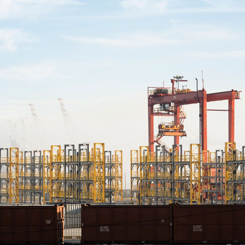 Straddle carrier and containers stand still in harbour during Covid-19 travel ban