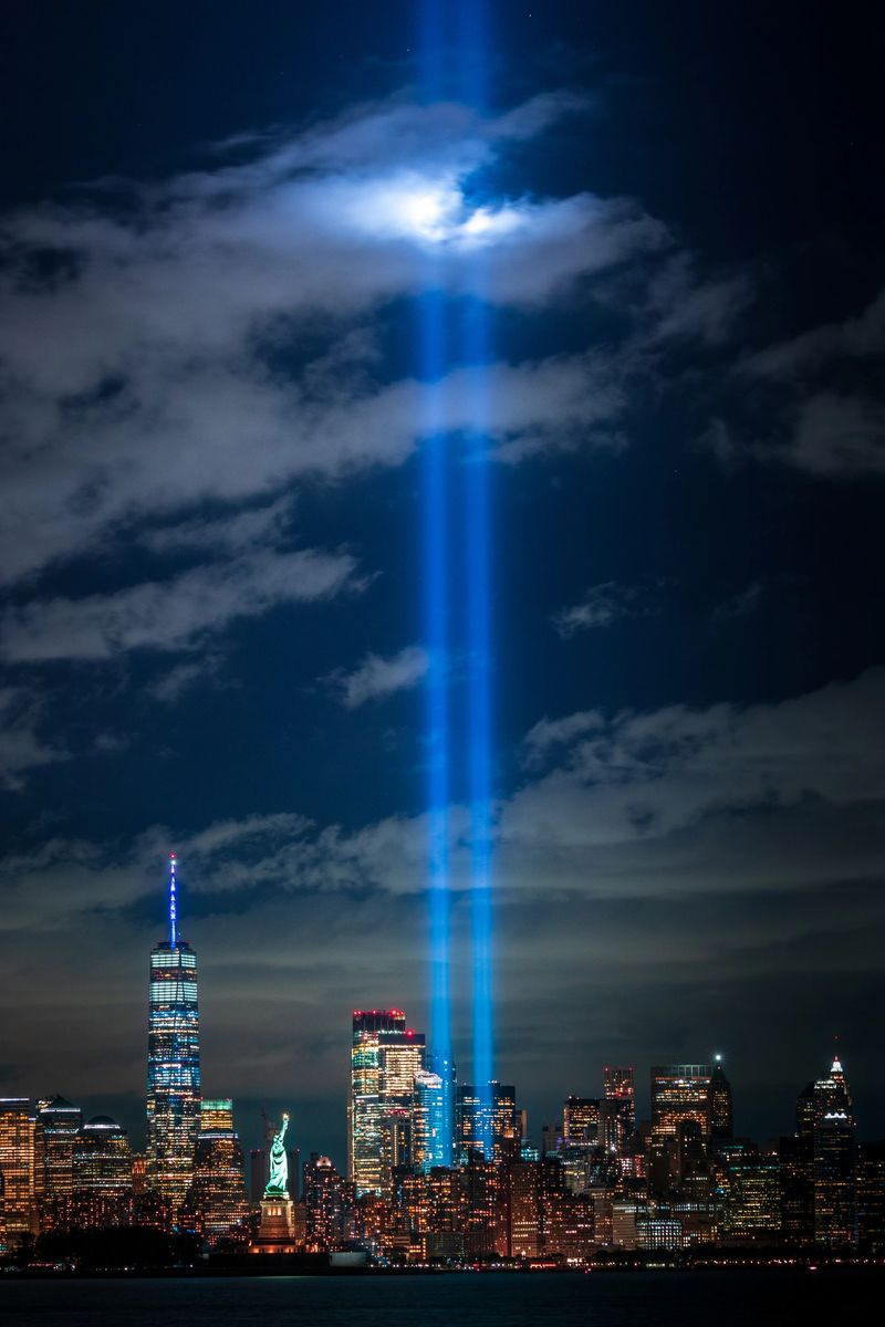 New Jersey - September 11, 2020, The Tribute in Light 9/11 memorial with the Statue of Liberty. New York City, USA