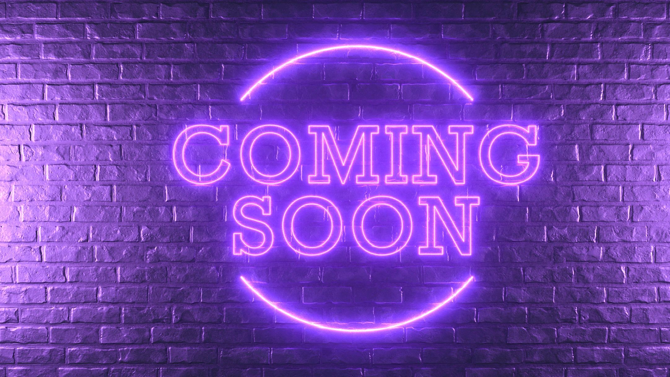 Purple neon sign saying 'COMING SOON' on a brick wall.
