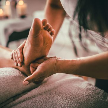 Reflexologist giving a foot reflexology treatment