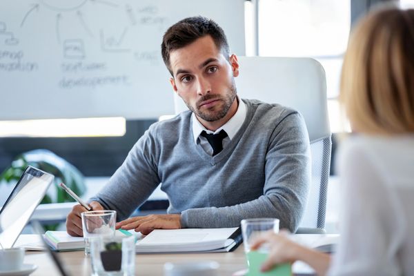 Man in a meeting attentively listening.