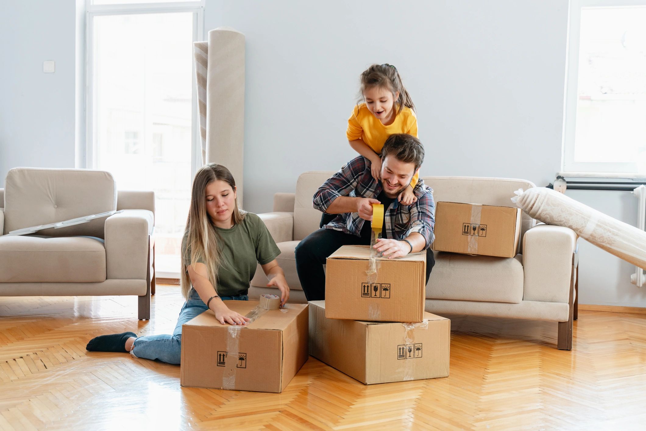 Family packing boxes in a new home.