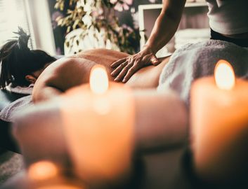 Man receiving a hot stone massage on his back.