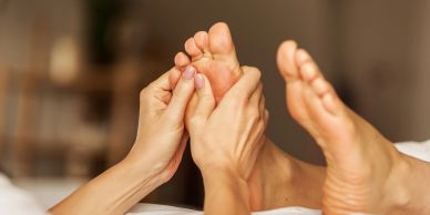 Person giving a foot massage.