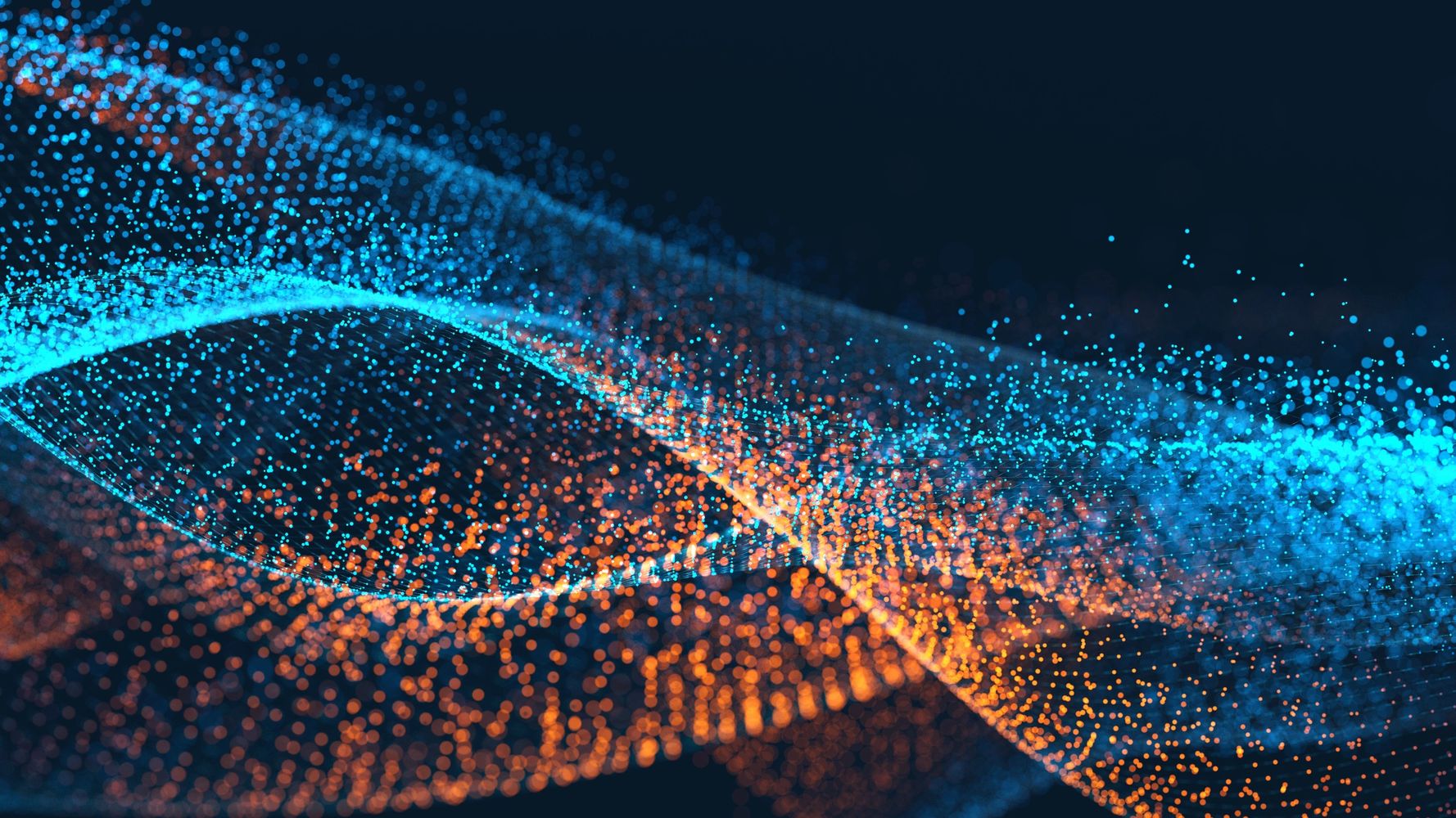Abstract wave of glowing blue and orange particles on dark background.