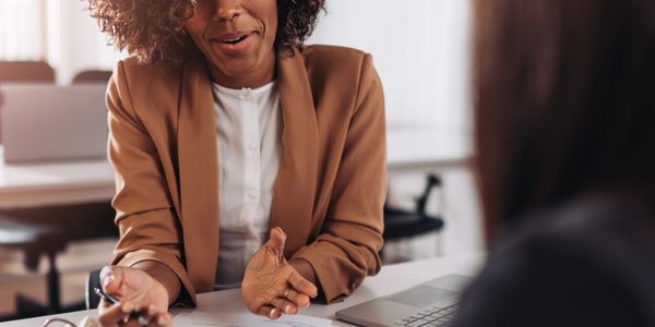 Businesswoman engaging in a friendly discussion during a meeting.