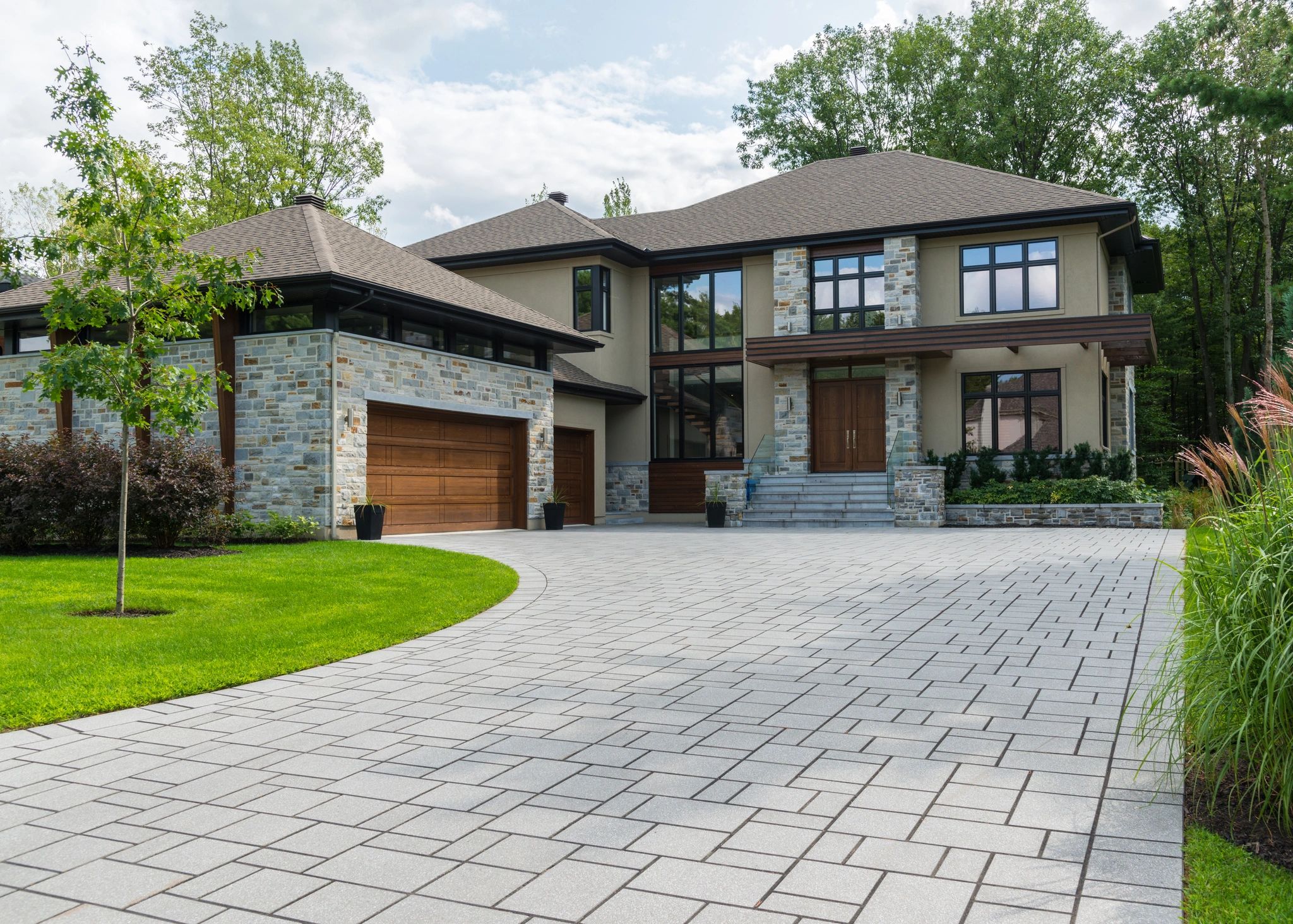 Modern two-story Custom house with stone accents and spacious driveway.
