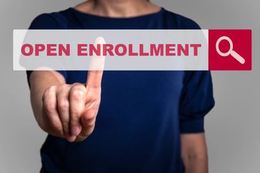 Person touching an open enrollment button.
