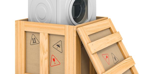 A washing machine inside a wooden crate.